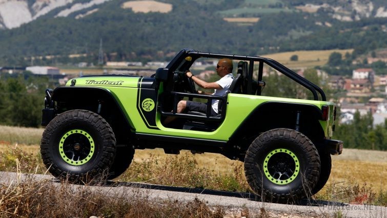 Jeep Trailcat по дороге на фоне гор Jeep Trailcat по дороге на фоне гор
